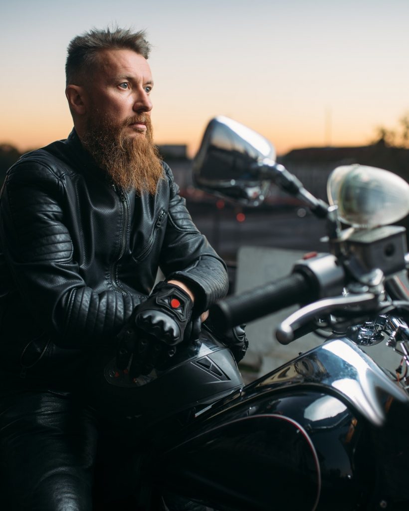 biker-poses-on-a-motorcycle-in-city-on-sunset.jpg